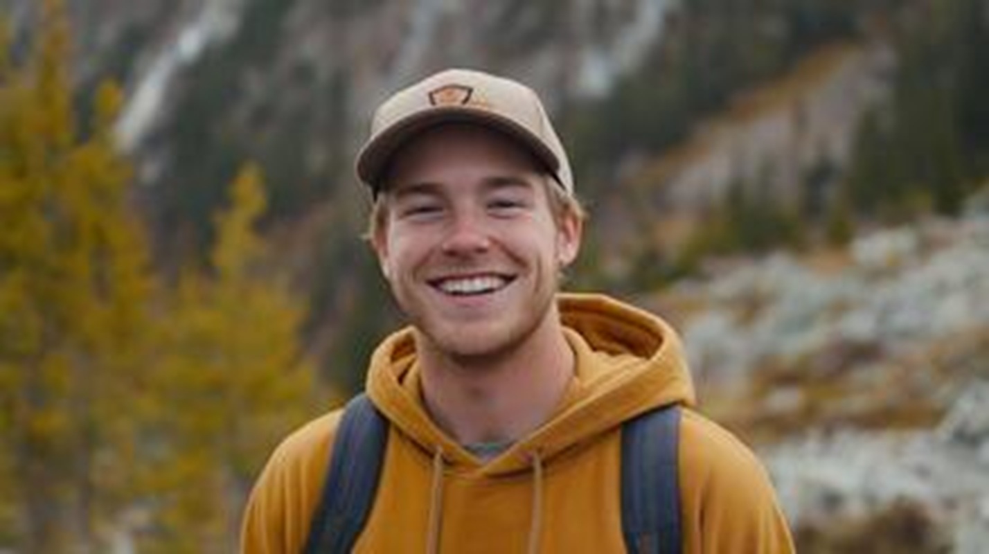 young-man-with-freckles-and-baseball-cap-smiling-outdoors-in-autumn-mountain-landscape-background-photo.jpg